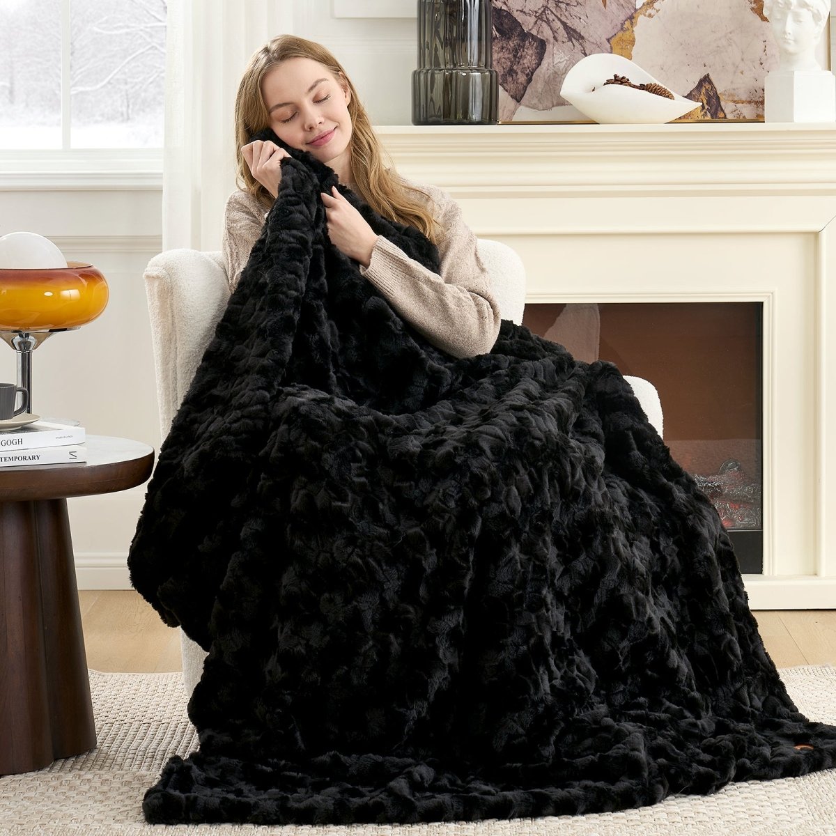 Woman relaxing under the Cozy Bliss faux fur throw blanket with ultra-soft plush comfort #color_Black