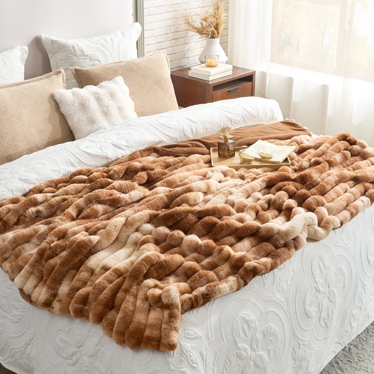 Brown textured blanket on a bed with pillows and a side table in the background. #Color_Tie-dye Brown